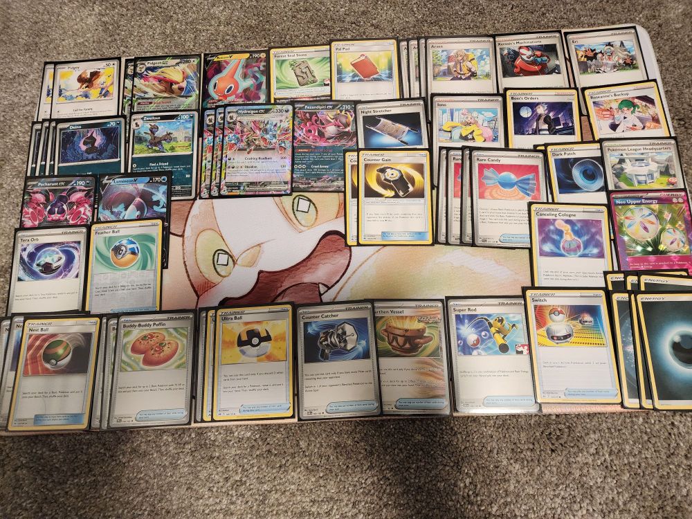 Pokemon cards on top of a yamper desk mat.