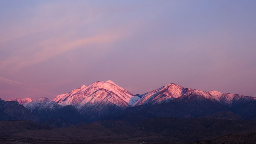 Snow covers Mt. San Gorgonio, tinged pink by the morning sun. 