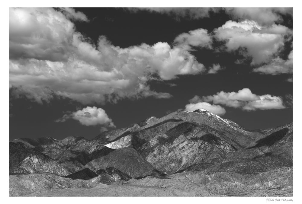 San Gorgonio mountain in southern California.  Layer of soft white clouds hang over the mountain.