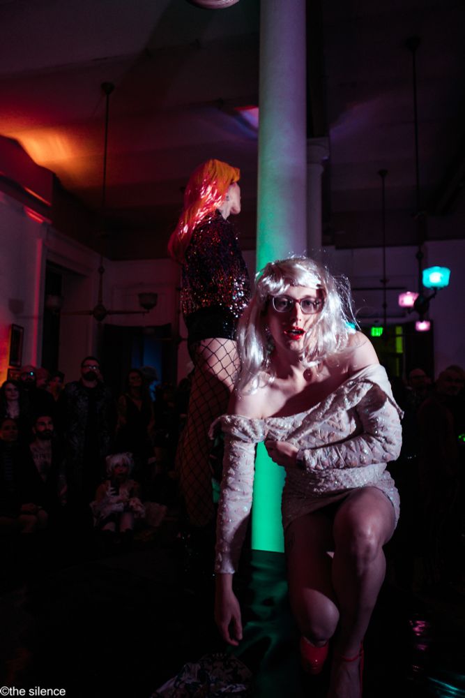 slab_me_harder where a horrible white sequin dress and a blonde wig looking dishevels into dh camera 