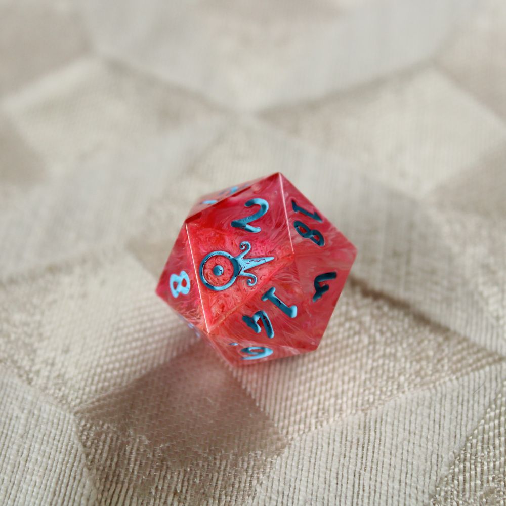 A single bright orange-pink d20 with bright blue numbers.