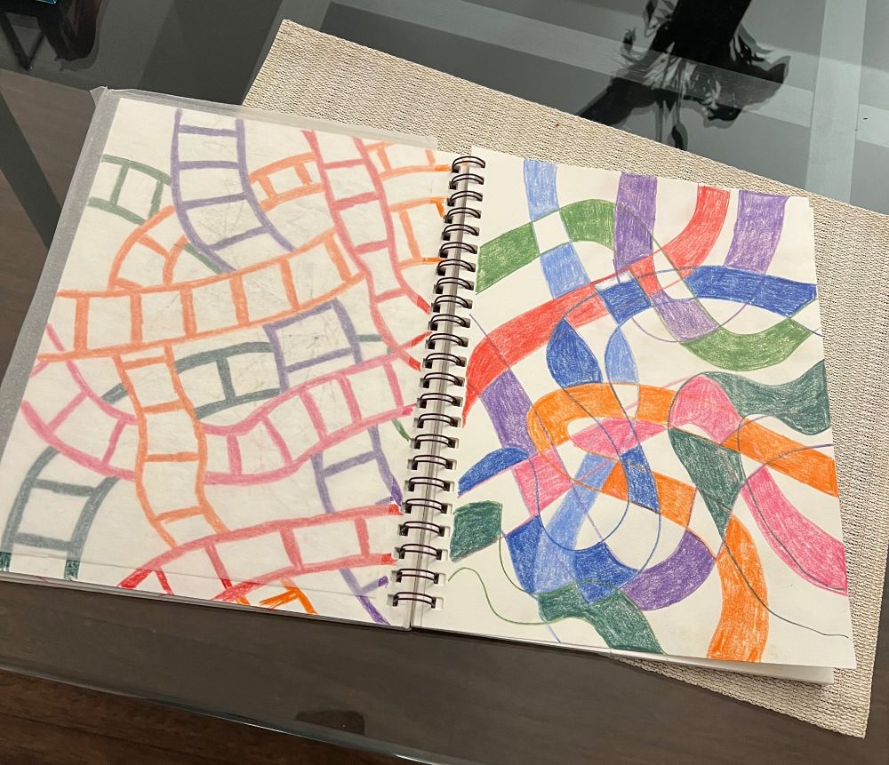 A two-page spread in my sketchbook of colorful, meandering lines.