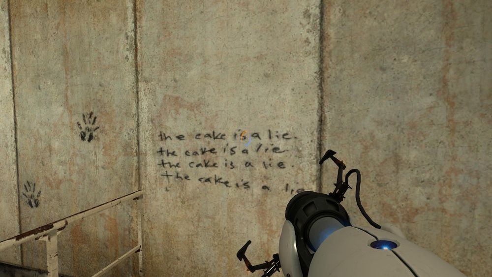 Portal screenshot. "The cake is a lie" scrawled on the wall.