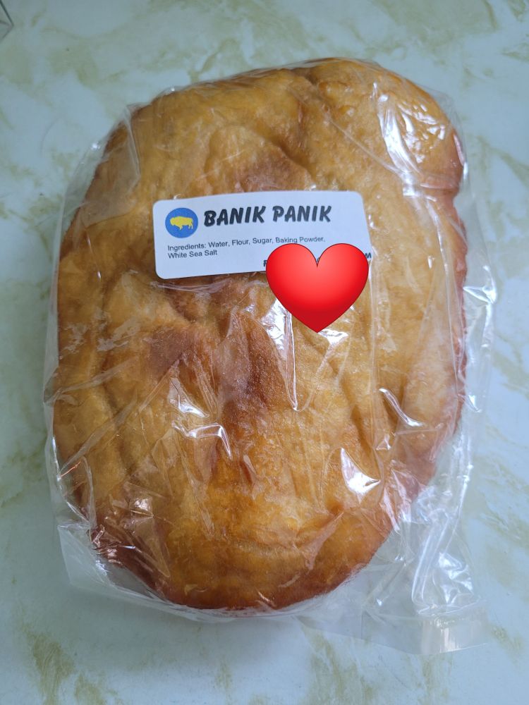 Oval-shaped flat loaf of bannock in a plastic bag 