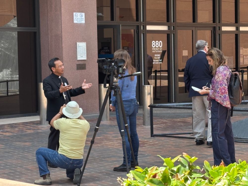 Bishop in his religious garb giving a press hit