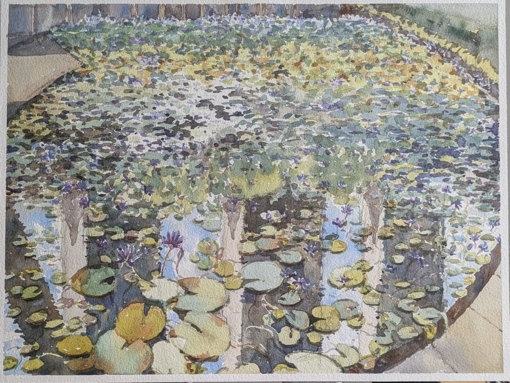 Watercolor painting of a Lily pond. Reflections of a blue sky and tall buildings. 