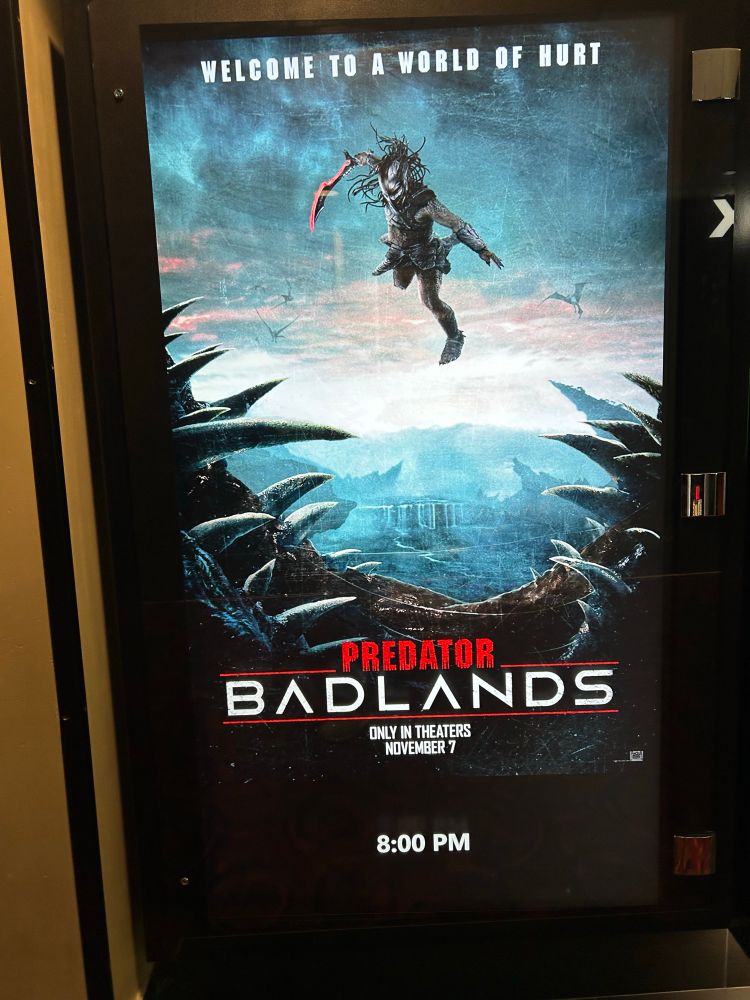 Theater poster for Predator: Badlands and an 8pm showing