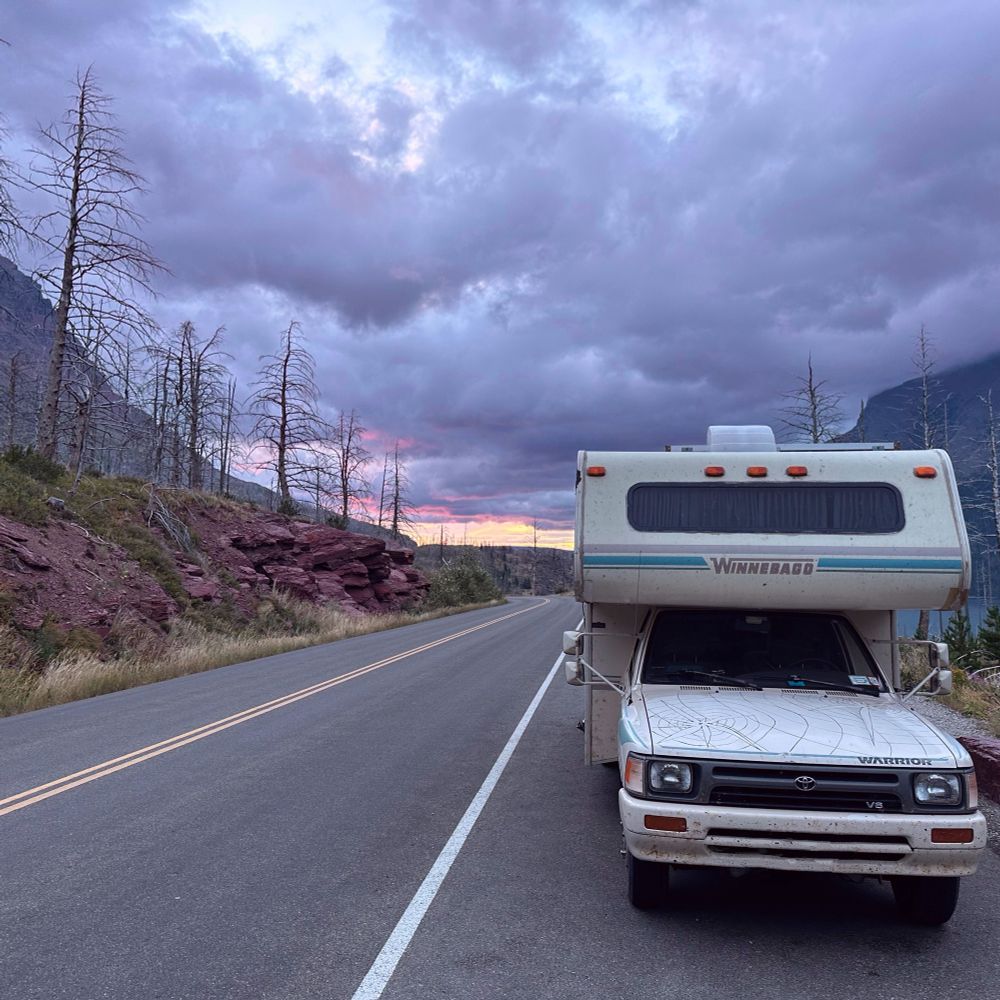 My Winnebago warrior parked on the side of the road in glacier national park. This photo serves as the cover art for Adventure Van Vol. I.