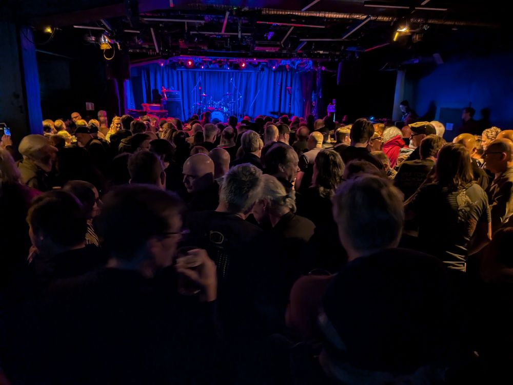 A crowd in front of an empty stage