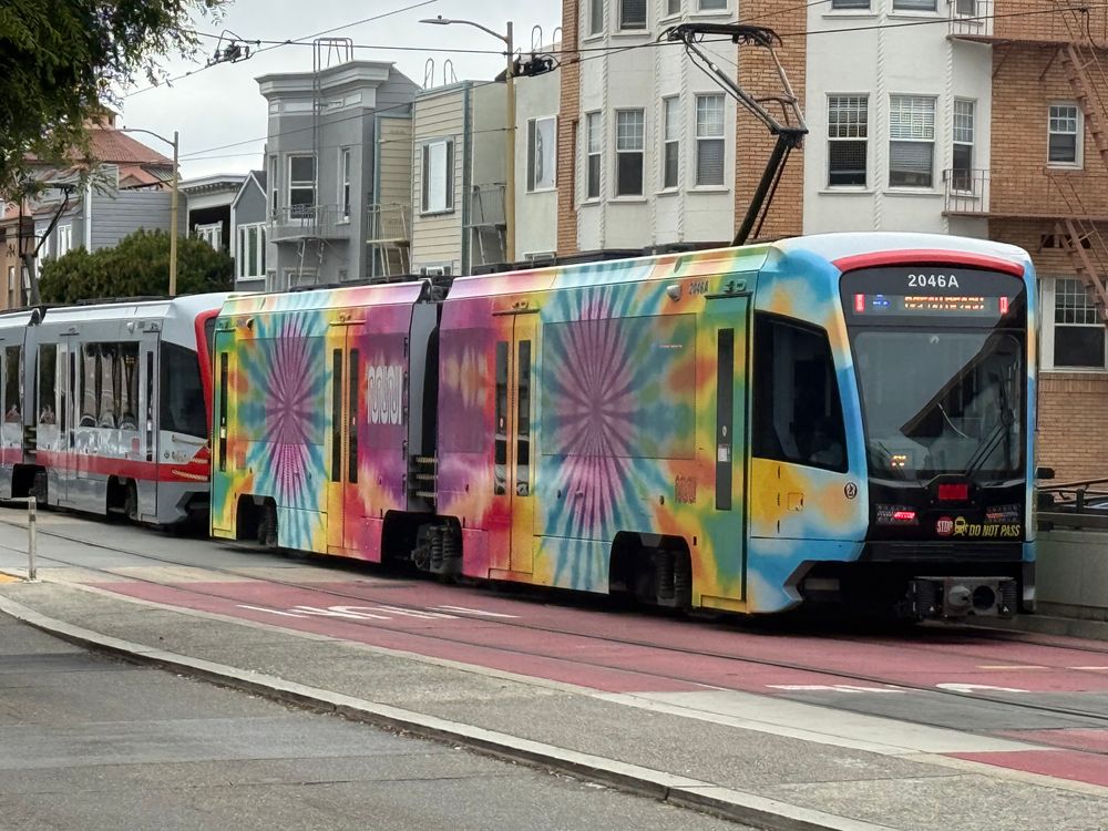 An N Judah LRV4 train with a tie dye style wrap