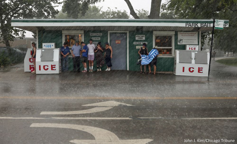 Beachgoers take shelter from the rain at the Park Bait Shop, 600 West Montrose Ave., during a thunderstorm Thursday, July 24, 2025, in Chicago. (John J. Kim/Chicago Tribune) 