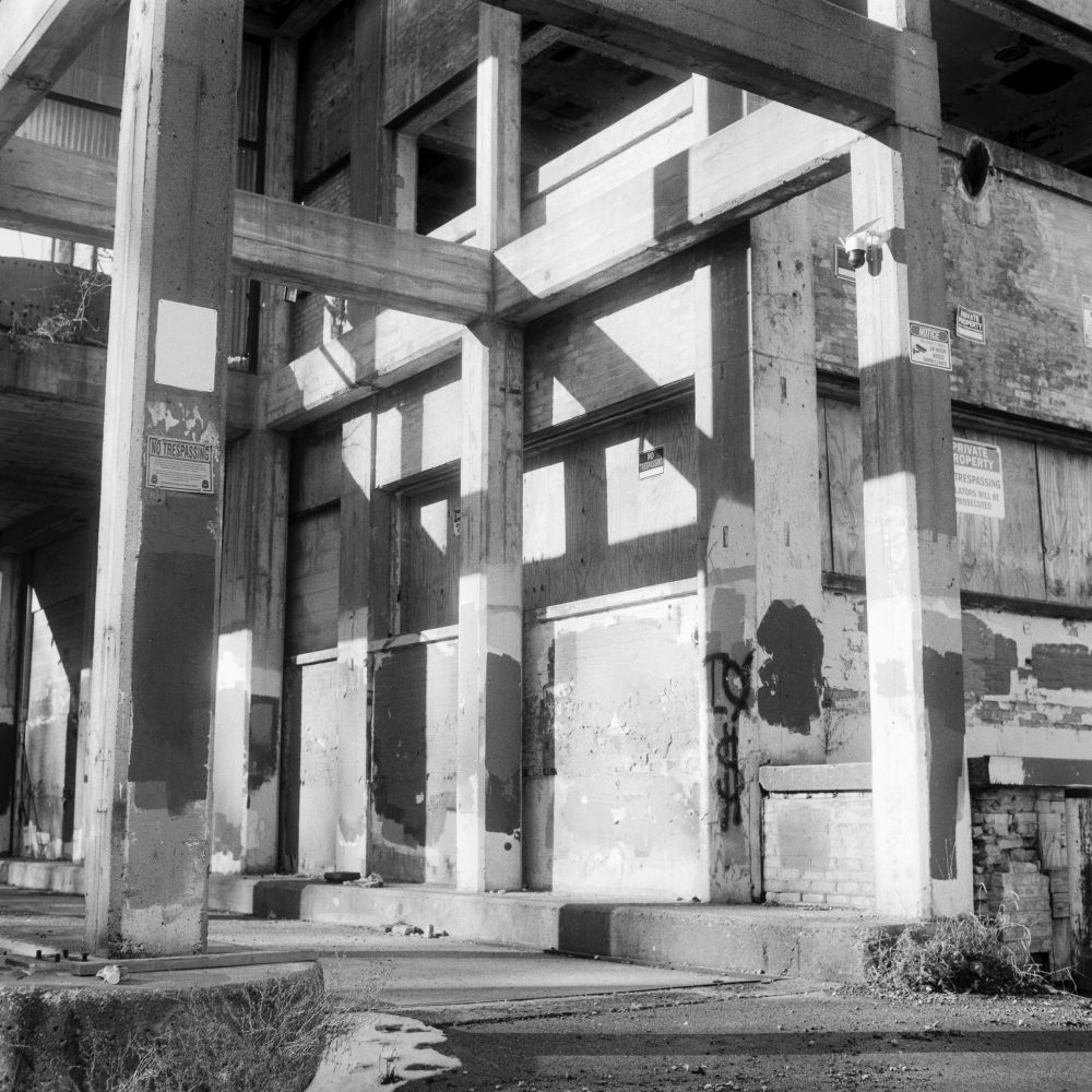 A black and white photo of an abandoned grain elevator building
