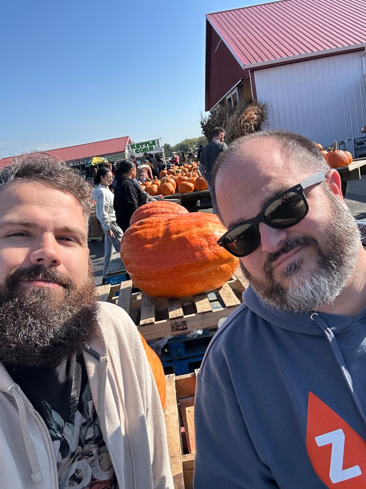 Two bearded men with a pumpkin in the background 