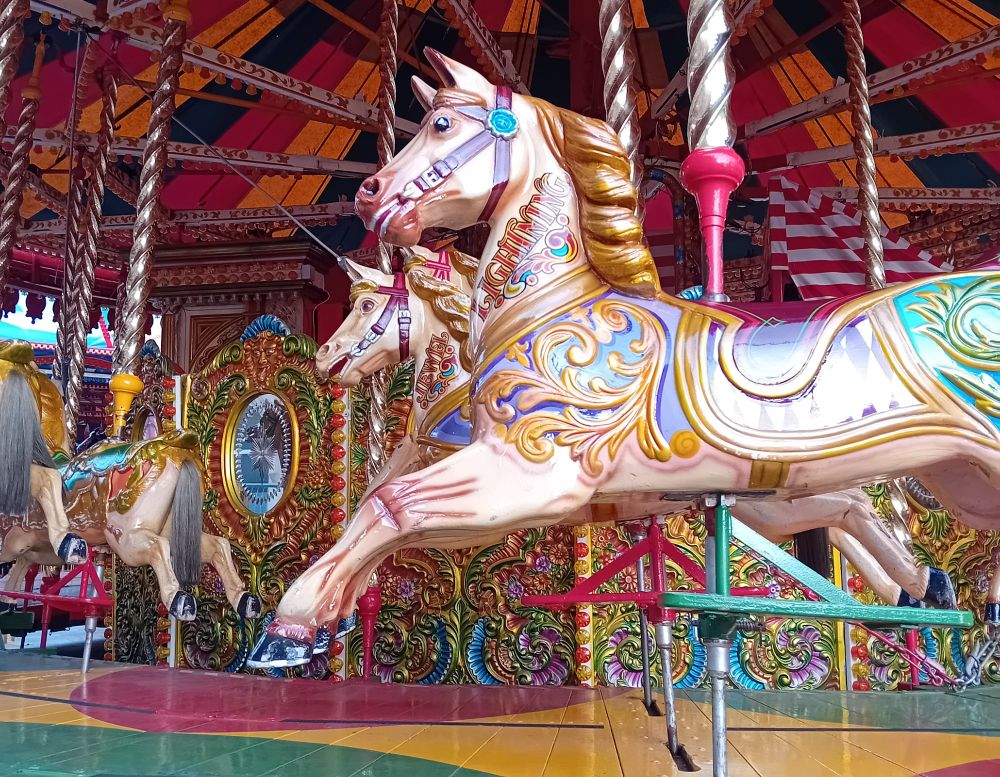 A photo of a carousel horse - behold the gaudy filigree and lurid colouring of this specimen named "Lightning" 
