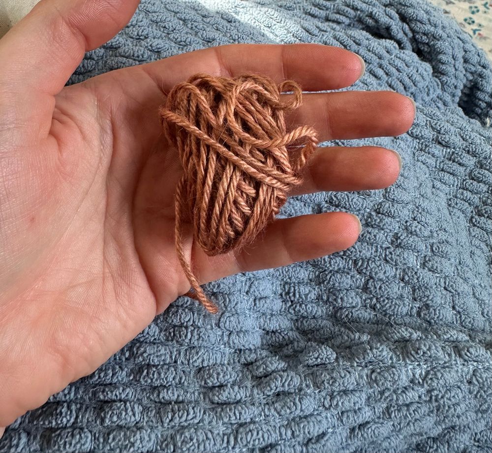 A very small ball of yarn, certainly not enough to knit 12 rows