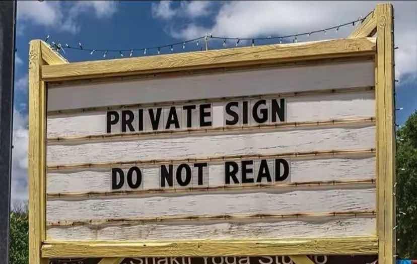 It’s a sign with text that reads “Private sign, do not read”