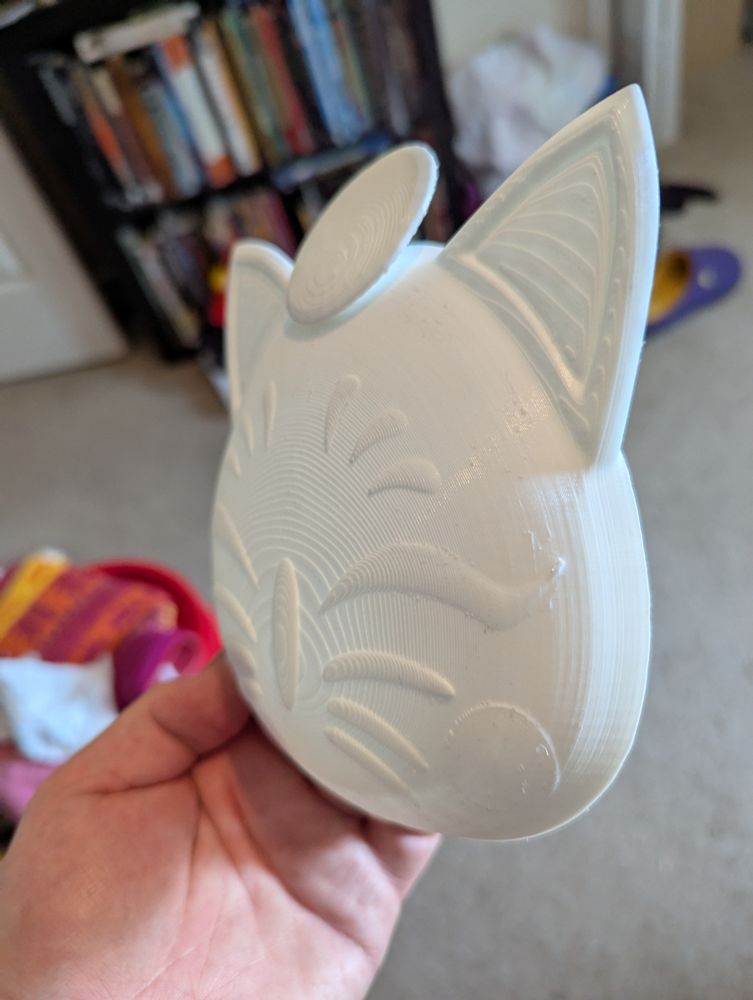 A side view of the Moogle moonfaire mask from FFXIV.