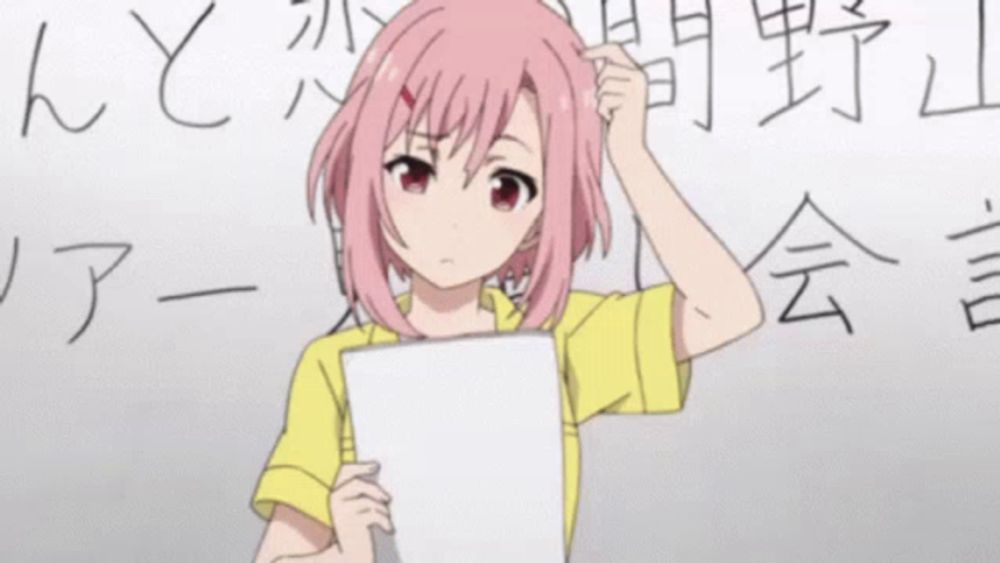 a girl with pink hair is holding a piece of paper in front of a board with chinese writing on it