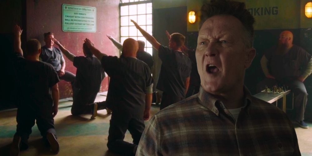 Peacemaker’s imprisoned father, neo-nazi White Dragon, is in the foreground with a terrible fash haircut just like neo-nazi Elon Musk’s. The villain’s white supremacist followers kneel behind him sieg-heiling.