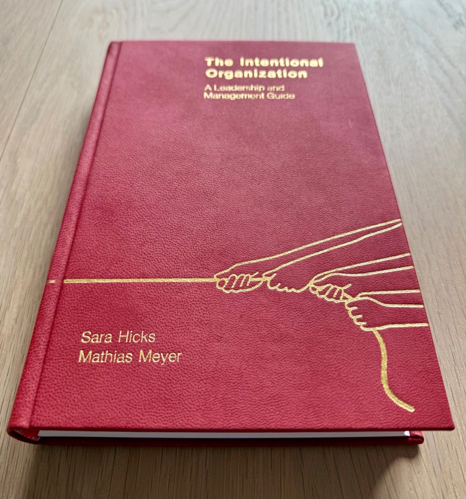 Front cover of a pleather-bound, limited-run version of the book "The Intentional Organization" by Sara Hicks & Mathias Meyer.