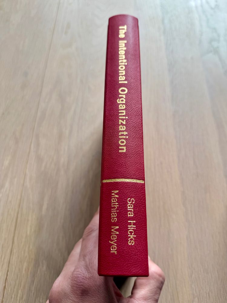 Spine of a pleather-bound, limited-run version of the book "The Intentional Organization" by Sara Hicks & Mathias Meyer