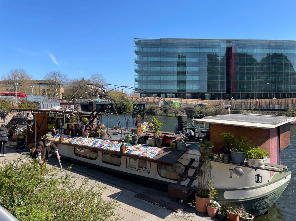 book shop on a narrow boat that is moored in a London canal 