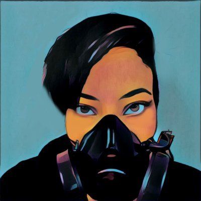 Artistic photo of woman with a half face gas mask on. Blue background. 