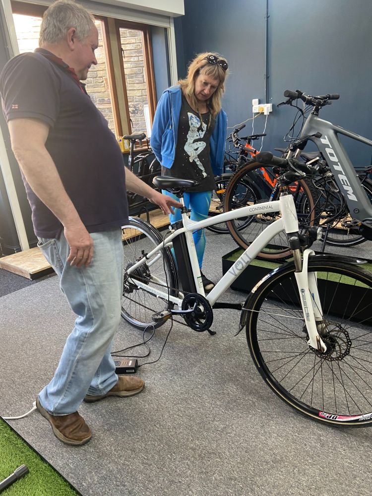 A photo of Carlton talking to Equal Care's Gill about one of the ebikes purchased with the Rotary Club grant