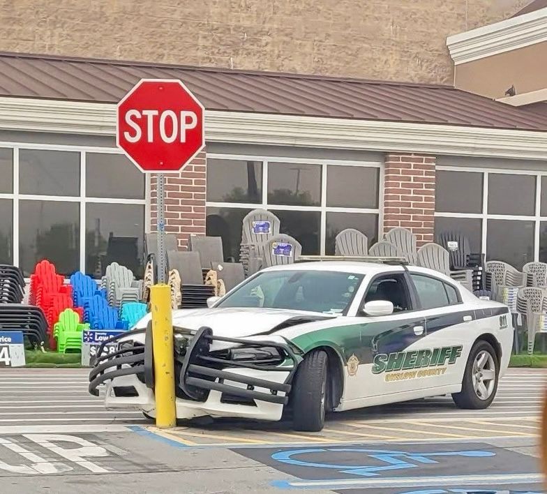 A Sheriff’s patrol car is squashed into a yellow bollard.