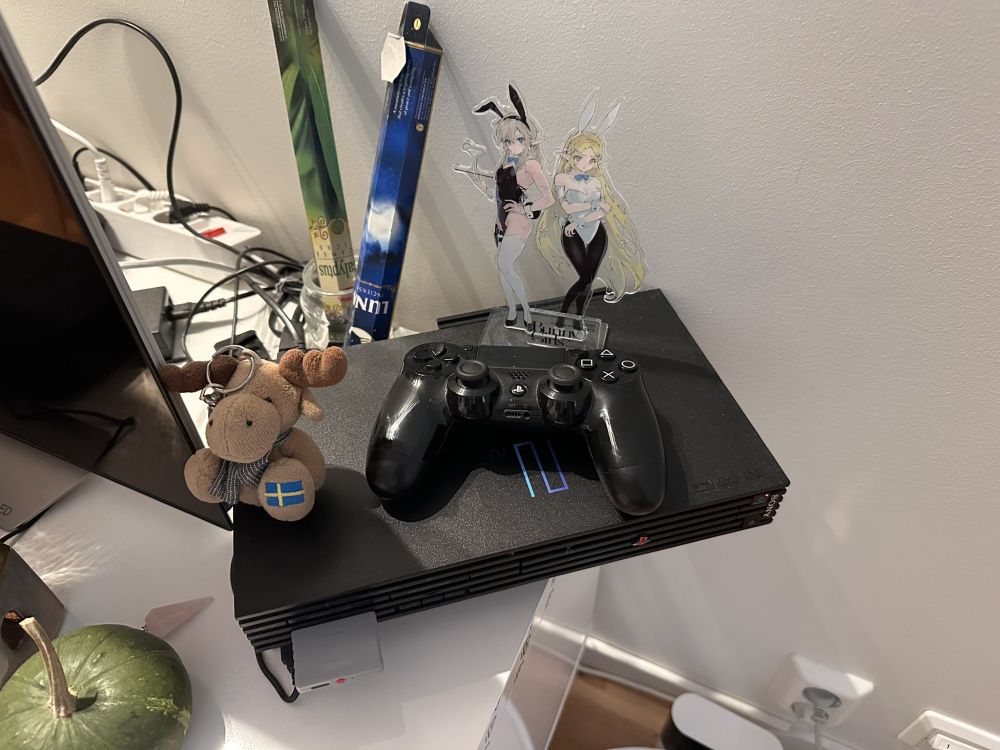 PS2 with 8bitdo adapter with a Dualshock 4 gamepad on top