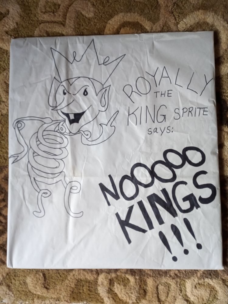 A version of Coily the Spring Sprite, a cartoon character made of springs, with a crown on his head. The caption says "Royally the King Sprite says: NO KINGS!!!"