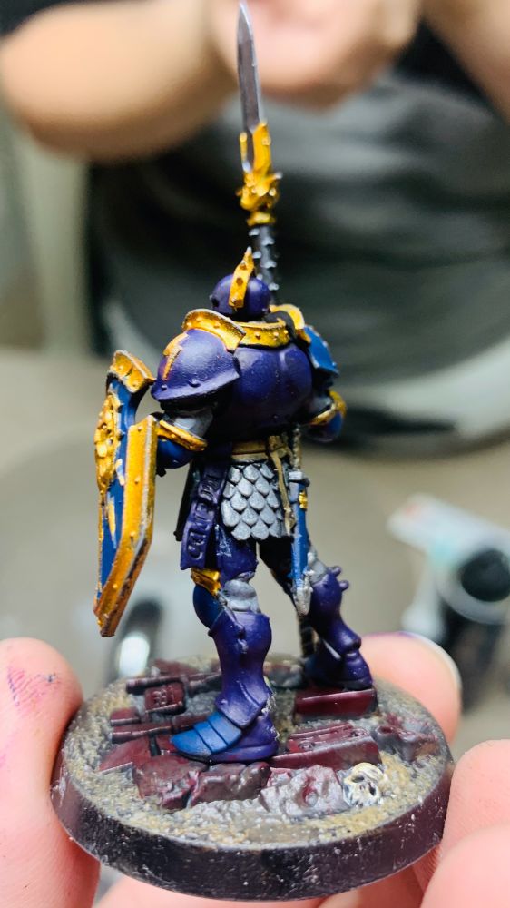 Side-Back View of Stormcast Eternal Vindictor with a primarily Purple-Blue color scheme and gold accents.
