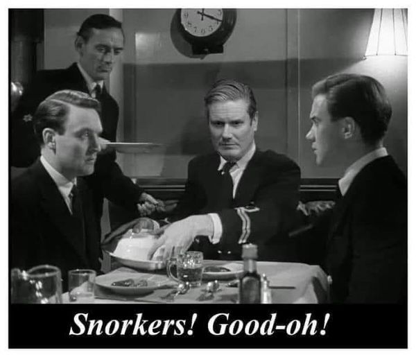 British naval lieutenants sit around a mess table. One of them exclaims “Snorkers! Good-oh!” While reaching for a serving dish. 