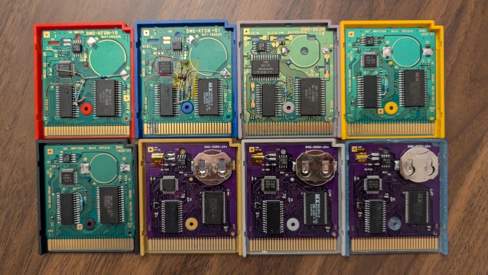 Same as the previous photo, except now the game cartridges have been opened to expose the circuit boards and the modifications made to allow the games to hold save data without the need for a battery backup.