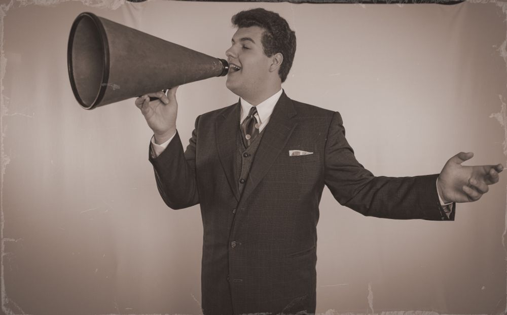 Hank Nelson singing through a megaphone 