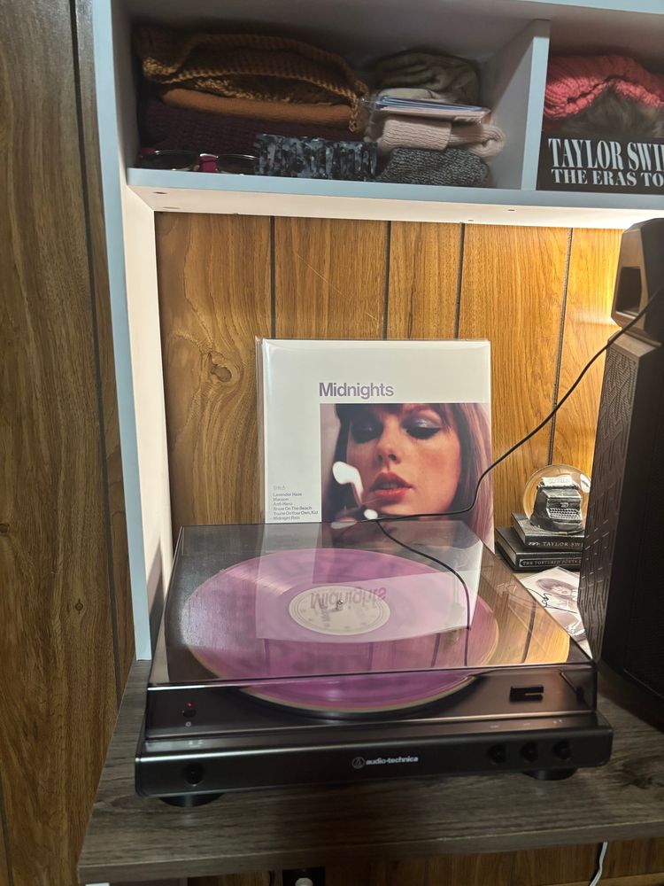 a record player spinning midnights by taylor swift, love potion purple variant lp