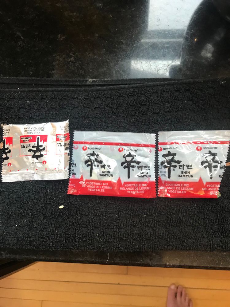 From left to right: a packet of seasoning, a packet of veg, and the miracle packet of veg. Also at the bottom right is my sexy naked foot for all that are into that kinda stuff. 