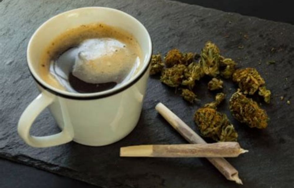 A cup of black coffee (I'm gonna say specifically the discontinued Foglifter™ with just sugar for the sake of the meme) in a plain mug like what you'd find at a diner, sitting next to a couple joints and some weed nugs