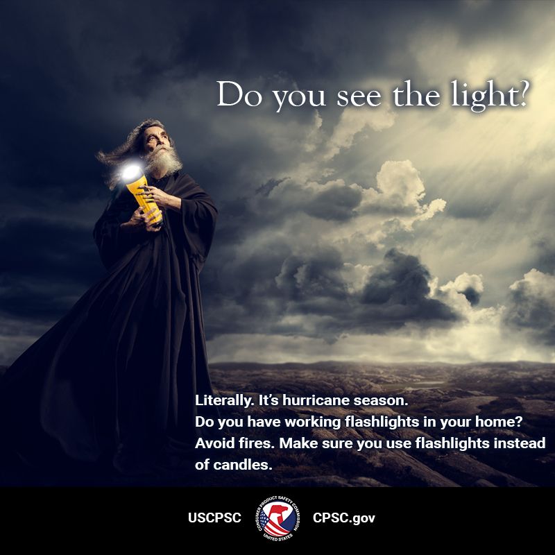 An old man with a long beard wearing a big robe holding a lit flashlight. They are staring at the sky where a beam of light is breaking through some dark clouds. The text reads: Do you see the light? Literally. It's hurricane season. Do you have working flashlights in your home? Avoid fires. Make sure you use flashlights instead of candles. 
