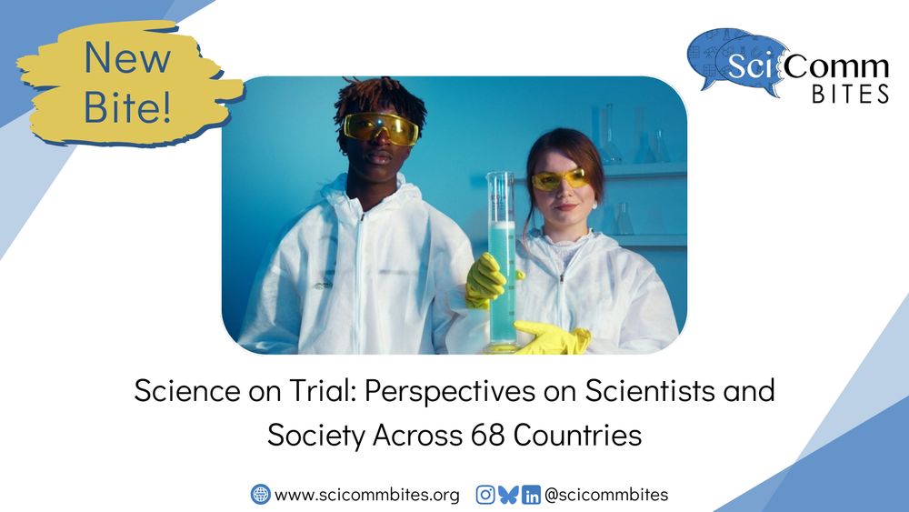 Two scientists in yellow goggles, white coveralls, and yellow gloves holding a graduated cylinder containing foamy blue liquid