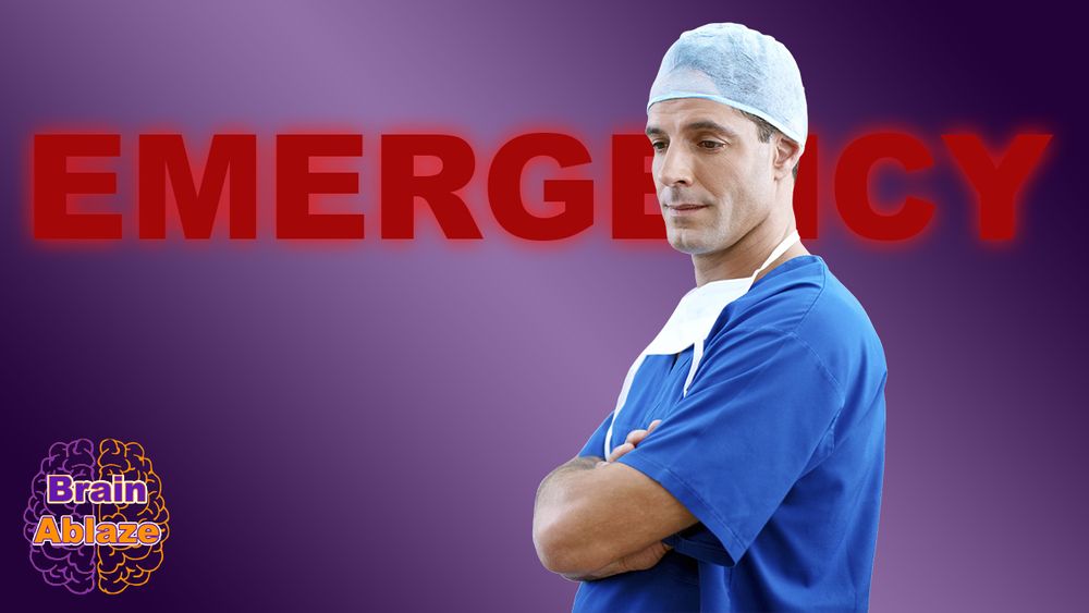 A man wearing scrubs stands in front of an glowing EMERGENCY sign. 