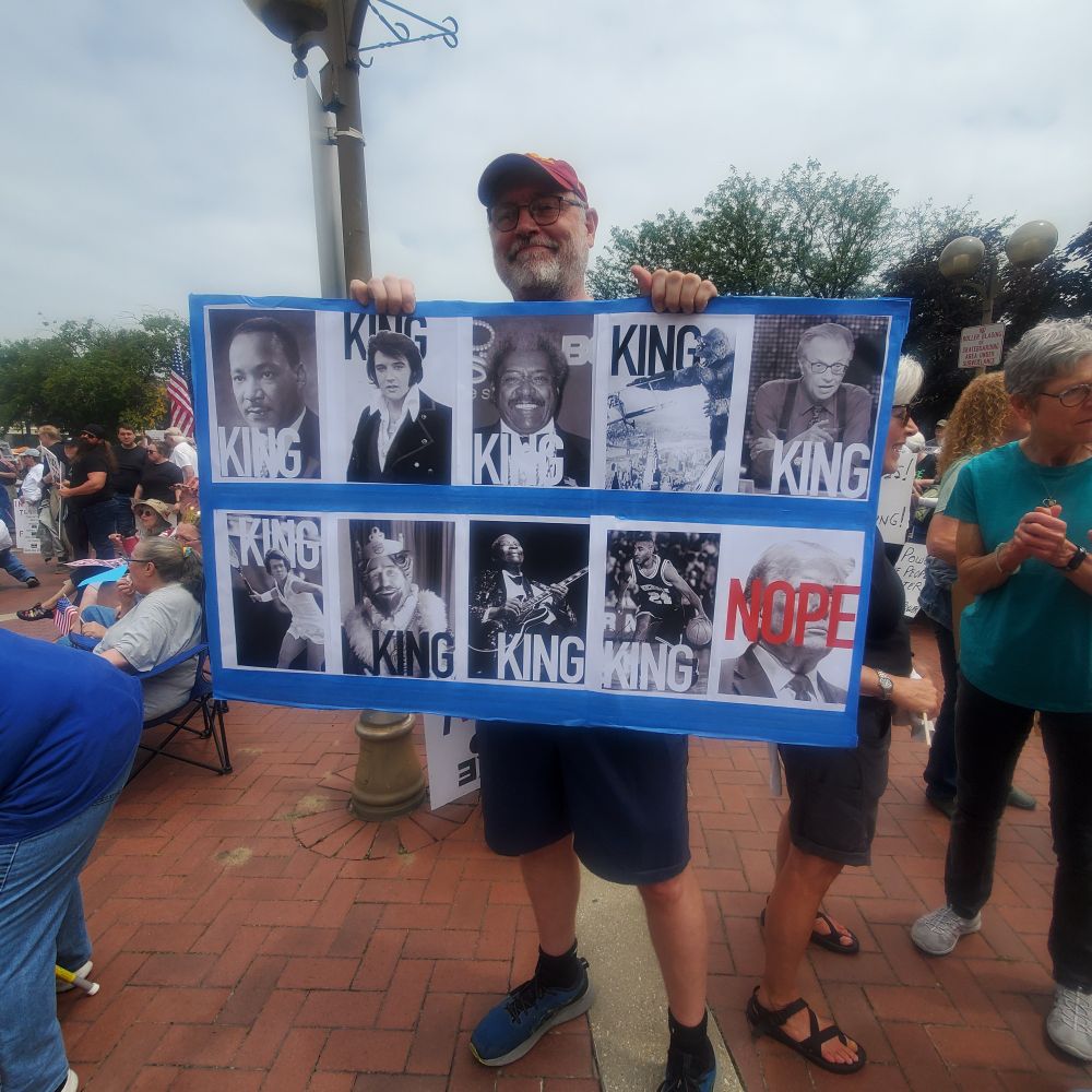 Protest sign with pictures of Elvis and various kings and a big nope over Trump's face.