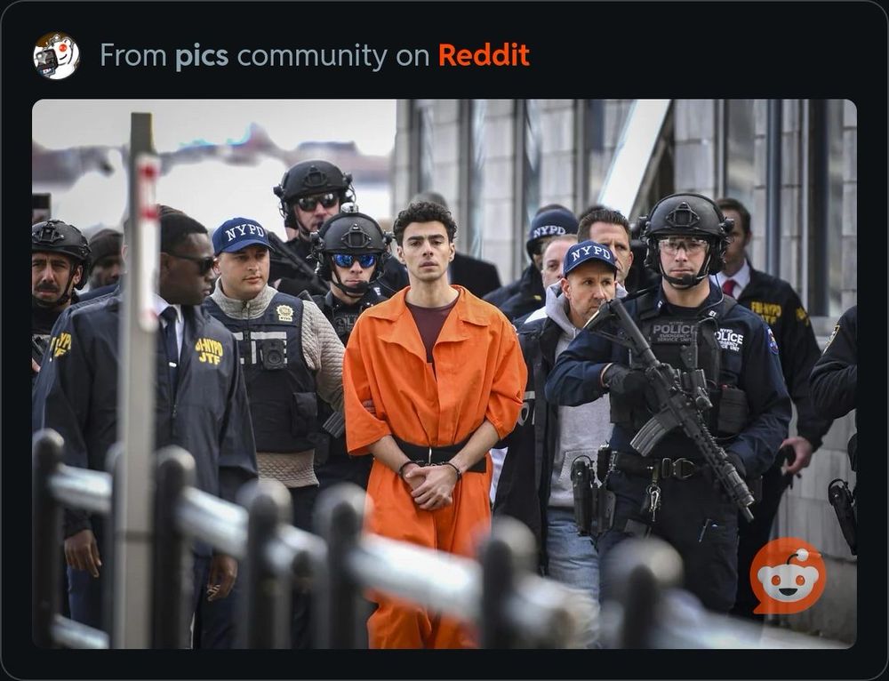 Luigi Mangione being perp walked surrounded by heavily armed police, notably not wearing any kind of protection himself. 
