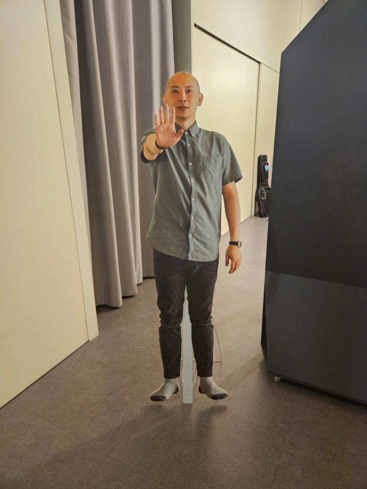 a standee of some bald guy 