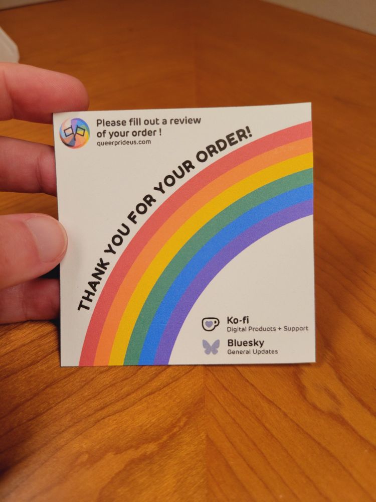 Square card with a rainbow arching across it with the text "thank you for your order!" above it. Top left corner has QueerPrideUS logo next to the text "Please fill out a review of your order" followed by "QueerPrideUS.com". The bottom right corner has logo the for Ko-fi listed as "digital products + support" followed by the logo for Bluesky listed as "general updates".