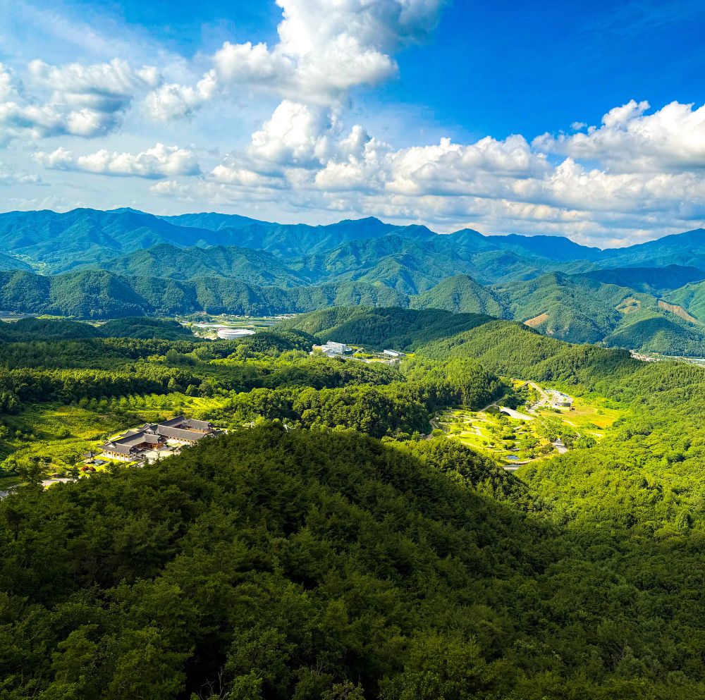View in Muju, South Korea—green hills around Taekwondowon).