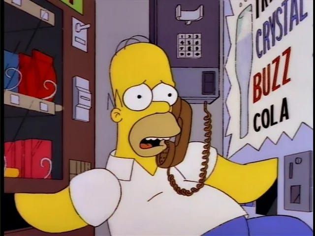 Homer Simpson with his hands in 2 vending machines