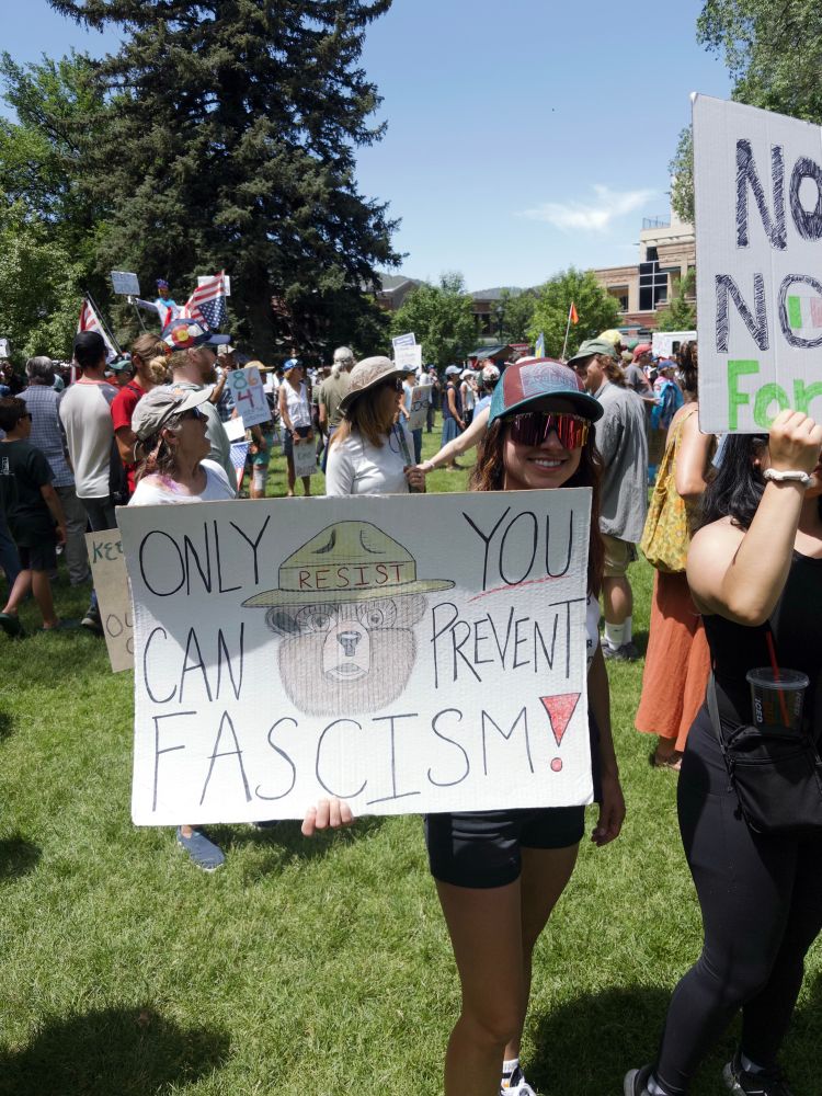Only you can prevent fascism. Protester with Smoky the Bear resist sign.