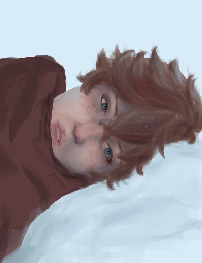 A red-headed boy is lying in the snow, looking at the viewer with his blue eyes. He has pale skin, a red nose, and rosy cheeks from the chill, and his red scarf is keeping his mouth and neck warm. his hair is covered with little snowflakes.
