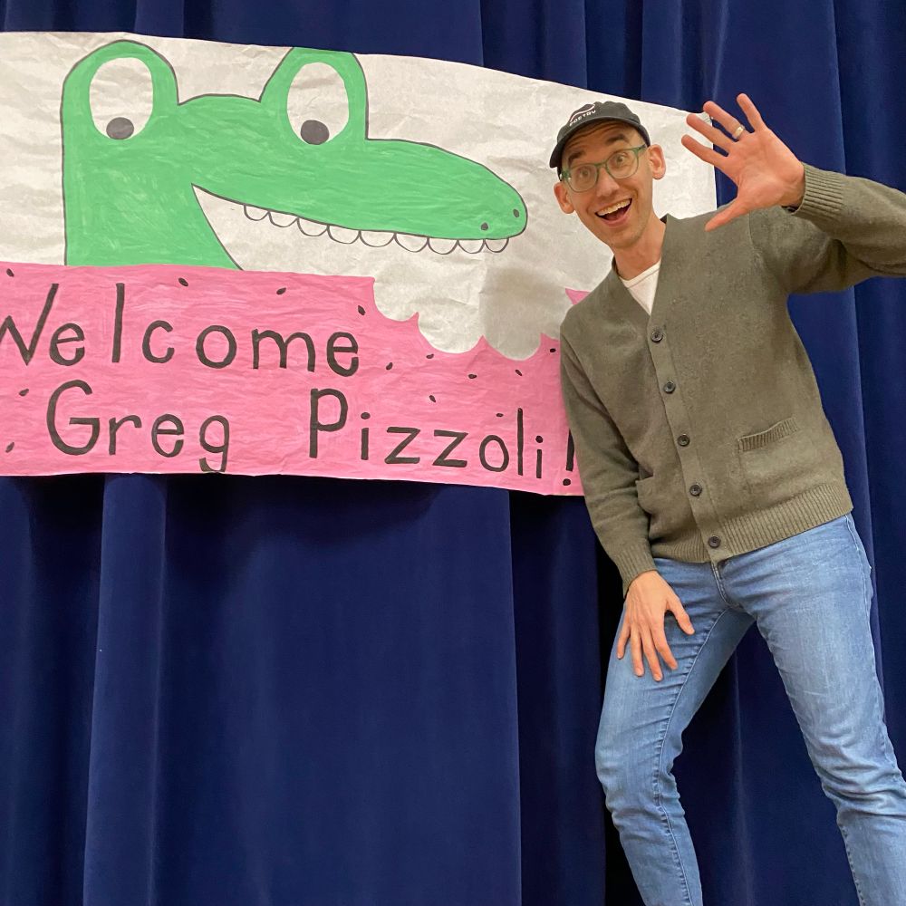 Author Greg Pizzoli smiles and waves